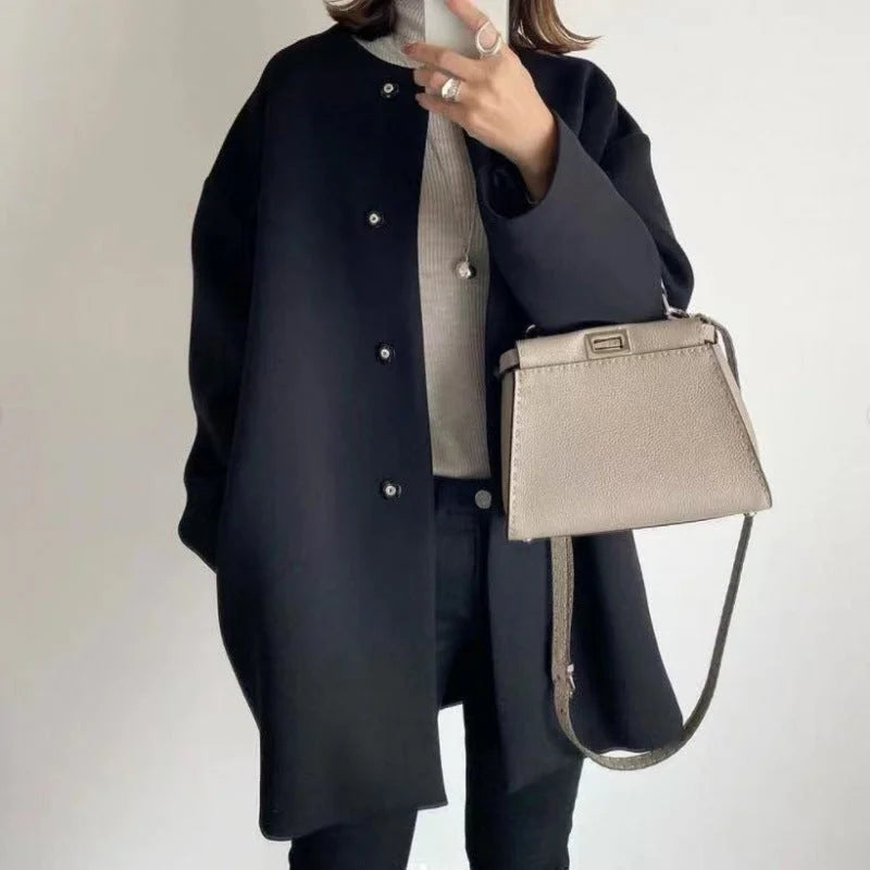Elegant women's oversized button coat. Ideal minimalist fall/winter outerwear & layering piece for chic style.