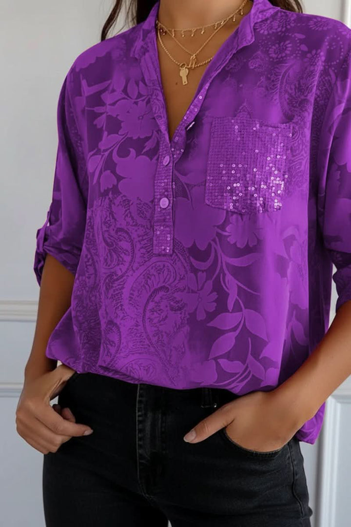 Modern women's chic printed blouse featuring a long-sleeve design, button closure, and a trendy front pocket.