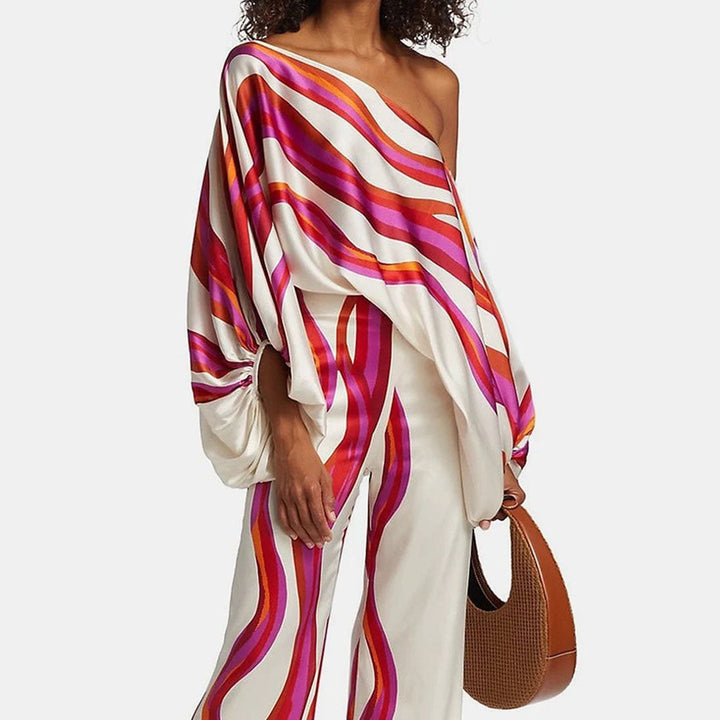 Women's chic printed one-shoulder two-piece set with wide-leg pants, perfect for resort or vacation wear.