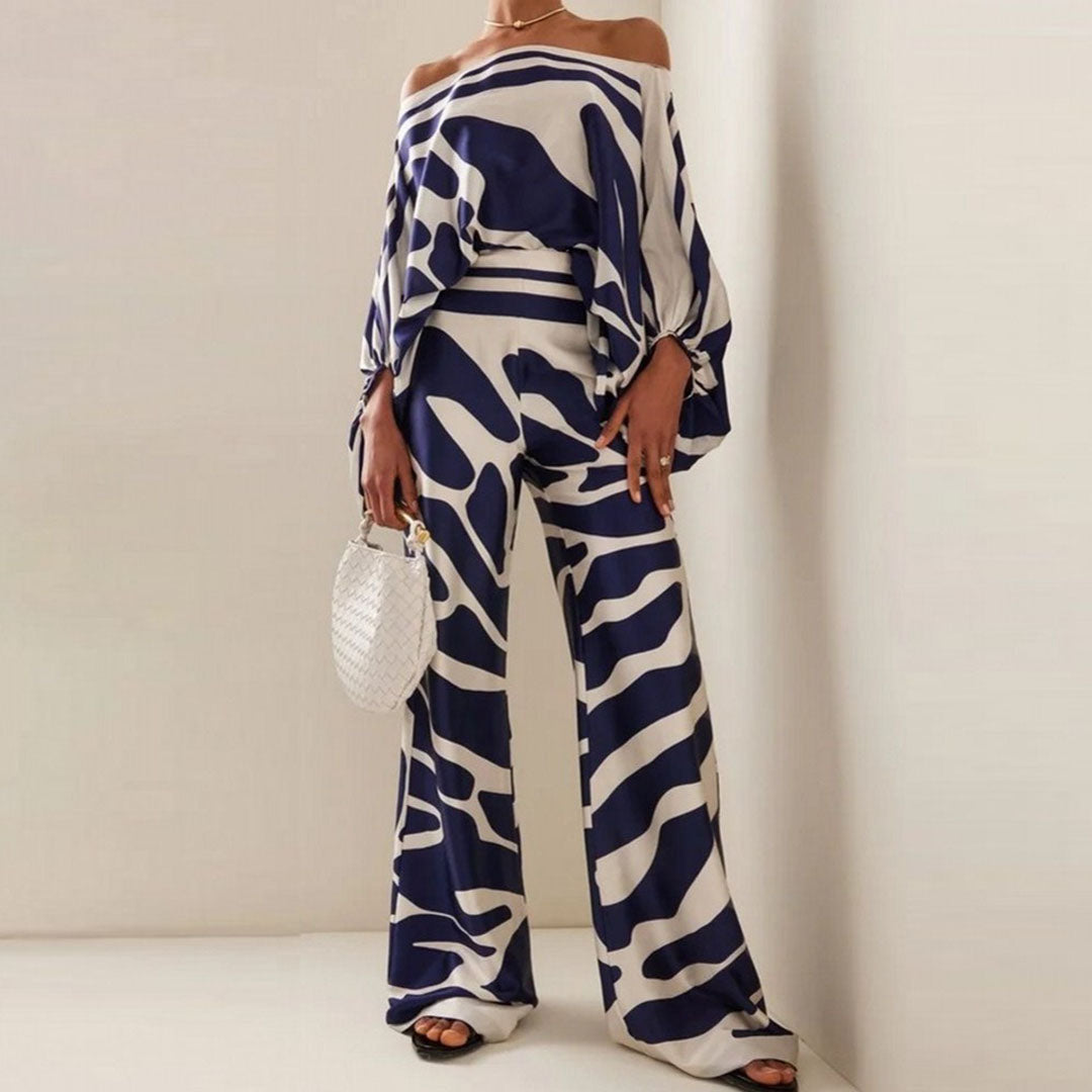 Chic women's abstract print two-piece set with a trendy one-shoulder top and comfortable wide-leg pants. Versatile.