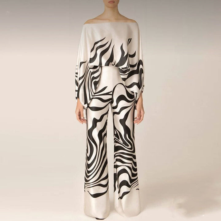 Vacation-ready women's one-shoulder two-piece set. Features a vibrant abstract print and comfortable wide-leg pants.