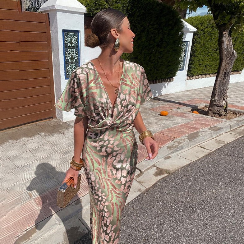 Elegant women's animal print maxi dress with twist front, a stylish long evening gown for special occasions.