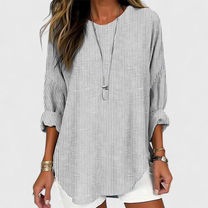 Versatile women's striped blouse featuring a comfortable crew neck. Chic casual top suitable for work or everyday fashion.