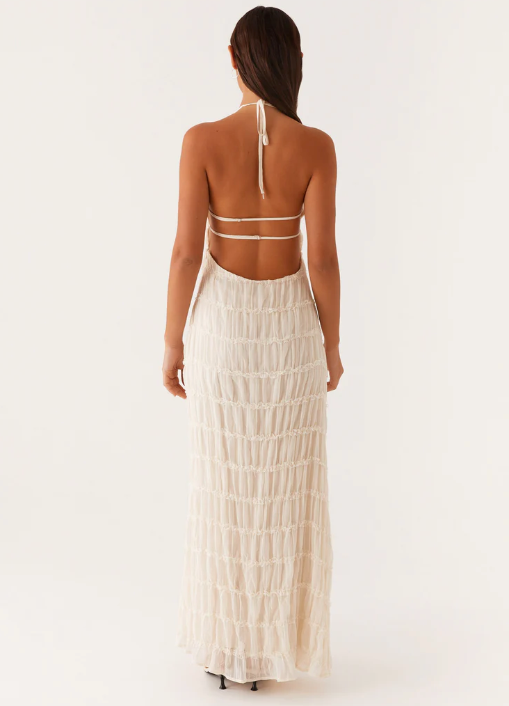 Flowing textured maxi dress with a flattering halter neckline, perfect for wedding guests.