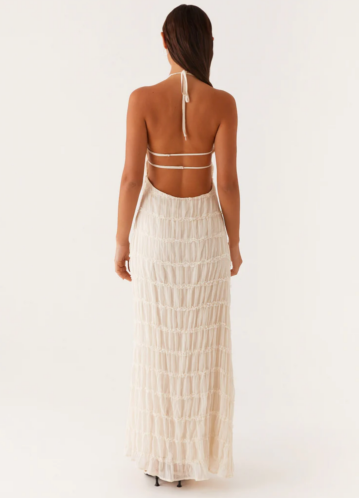 Flowing textured maxi dress with a flattering halter neckline, perfect for wedding guests.