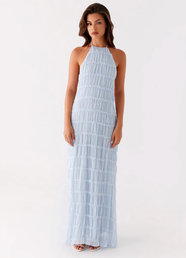 Chic maxi wedding guest dress with a textured halter design, ideal for evening events.