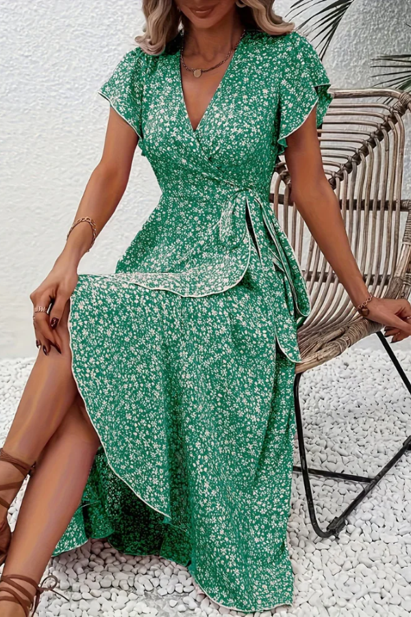 Women's V-neck floral midi dress on a hanger, showcasing its flowy design. Spring fashion ready.