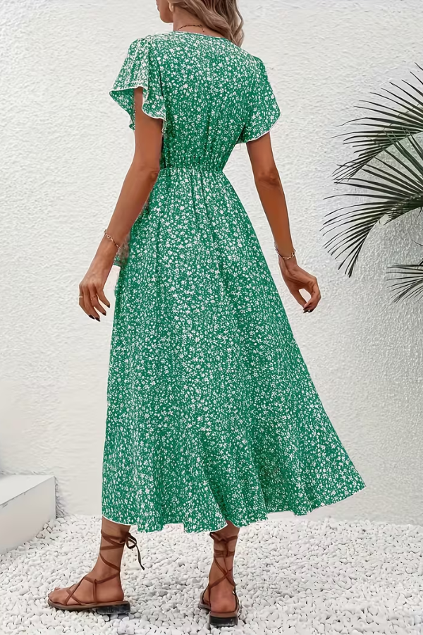 Flat lay: Chic V-neck floral midi dress, highlighting its vibrant print. Perfect spring fashion.