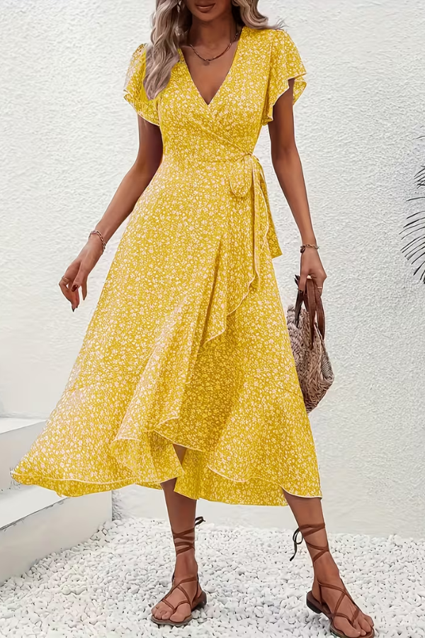 Women's V-neck floral midi dress styled casually with sandals. Lightweight summer fashion.