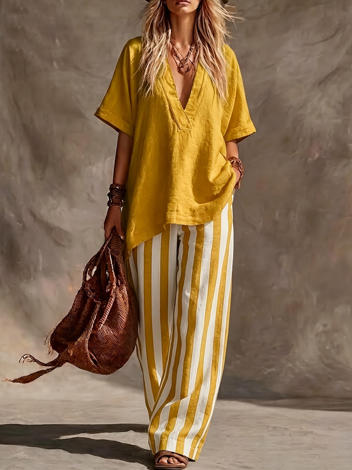 Relaxed fit women's V-neck top with high-waisted striped wide leg pants, a cozy two-piece outfit.