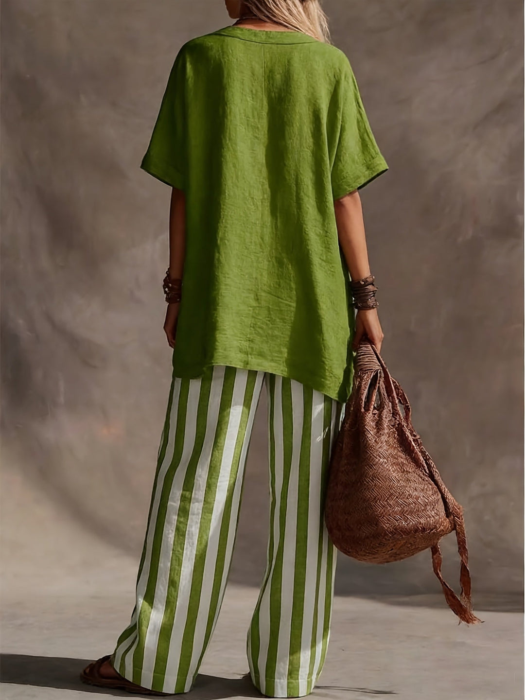 Women's summer fashion two-piece outfit featuring a stylish V-neck top and comfortable striped wide leg pants.