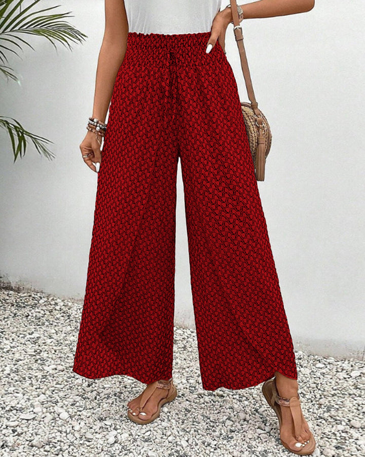 Printed women's wide leg trousers with a comfortable relaxed fit and modern geometric design. Versatile fashion bottom.