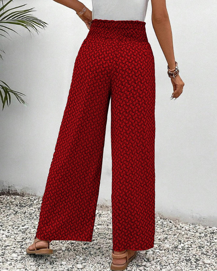 Modern women's wide leg trousers featuring a vibrant geometric print and relaxed, flowing silhouette.