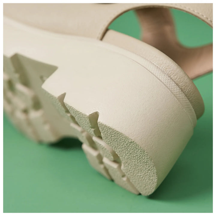 Close-up: Women's chunky platform wedge sandals, textured sole & adjustable strap. Stylish summer footwear.