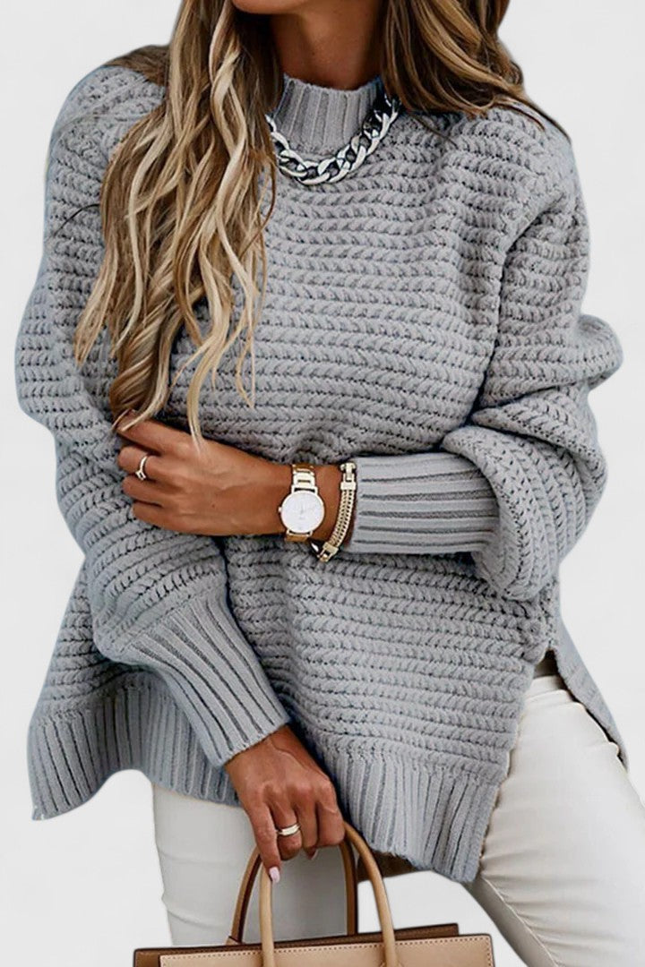 Stylish women's mock neck sweater with prominent chunky ribbing, offering a warm and fashionable knit for winter.