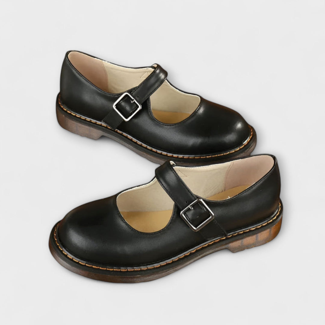 Classic women's Mary Jane flat shoes, black or brown, with a comfortable design, rounded toe, and secure buckle strap.