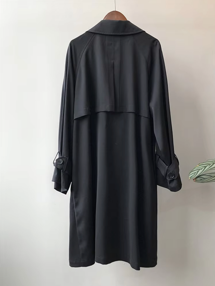 Stylish women's double-breasted trench coat. A classic workwear and business casual outerwear piece with lapel.