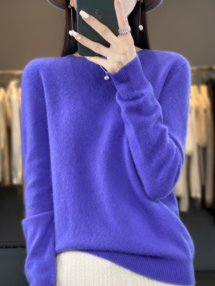 Close-up of soft knit texture on women's classic round neck pullover sweater.
