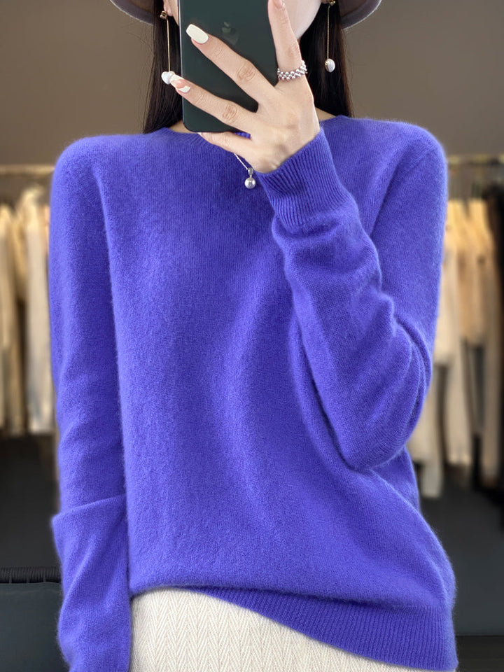 Close-up of soft knit texture on women's classic round neck pullover sweater.