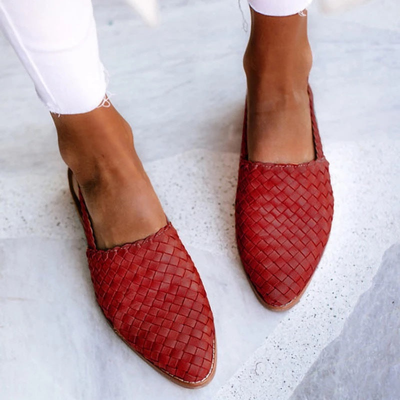Women's closed-toe flat slip-on mules. Comfort-focused backless design for versatile everyday footwear.