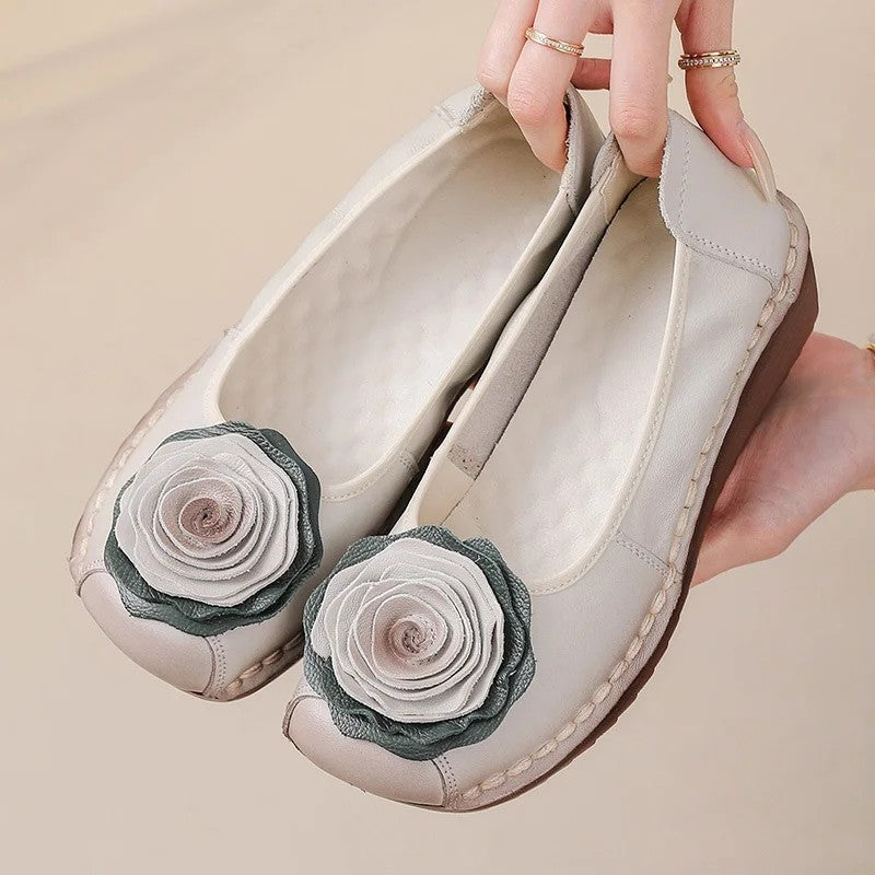 Women's comfort loafers with elegant floral appliqué. Easy slip-on style for everyday fashion.