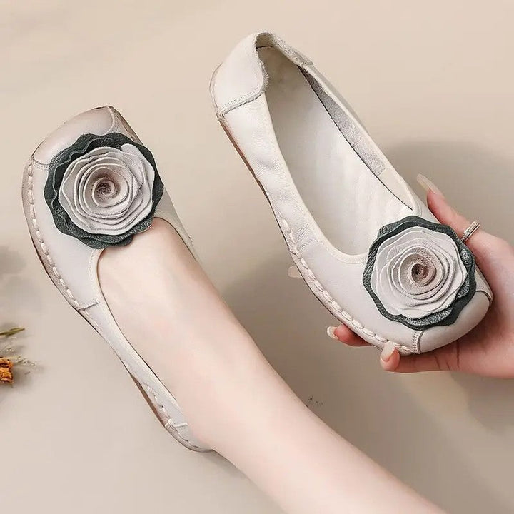 Soft, comfortable women's slip-on loafers. Features charming floral appliqué, ideal for spring fashion.
