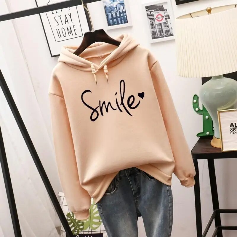 Women's comfort smile graphic hoodie, a cozy pullover for everyday casual wear.