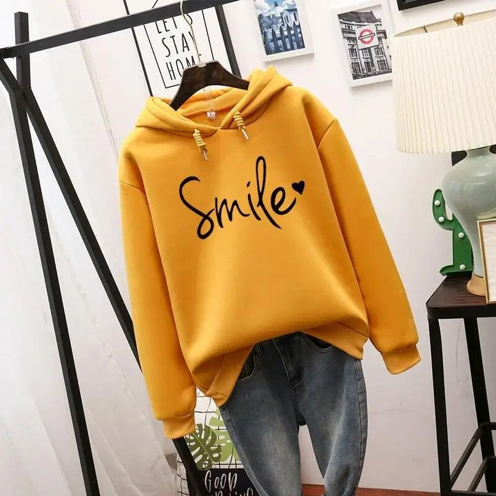 Relaxed fit women's comfort hoodie, a soft pullover with a distinctive smile graphic for casual style.