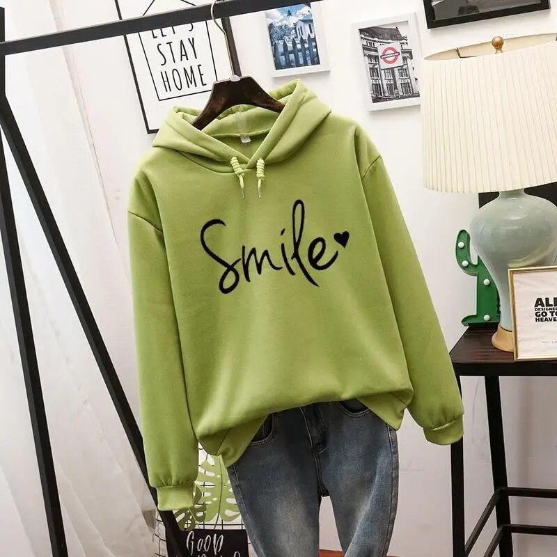 Stylish women's hooded sweatshirt, a comfy pullover with an uplifting smile graphic for positive vibes.