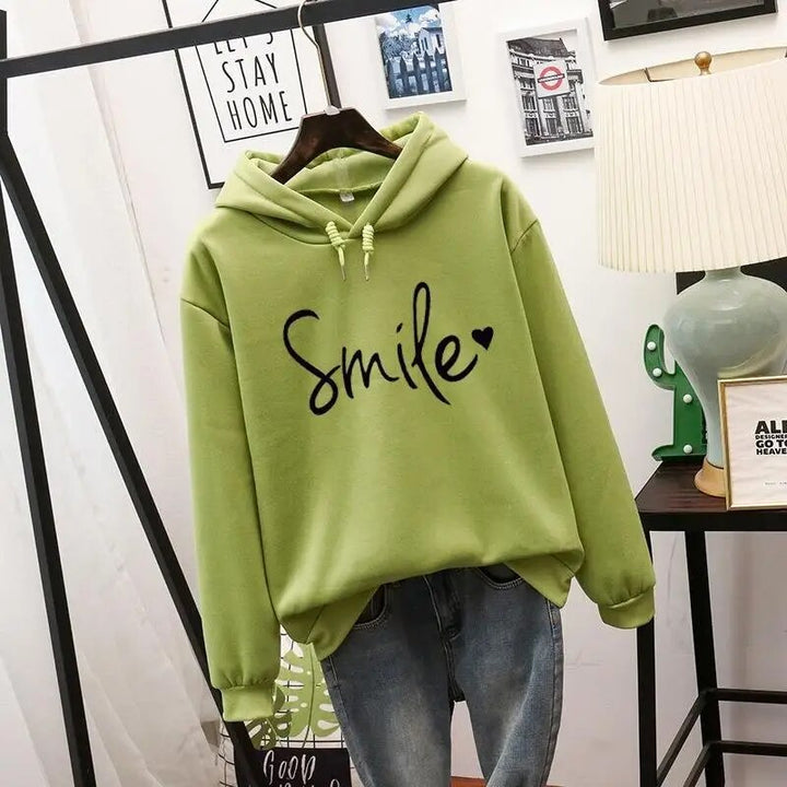 Stylish women's hooded sweatshirt, a comfy pullover with an uplifting smile graphic for positive vibes.