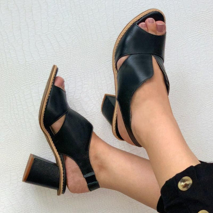 Profile view of women's comfortable block heel sandals. Stylish summer heeled shoes with buckle.