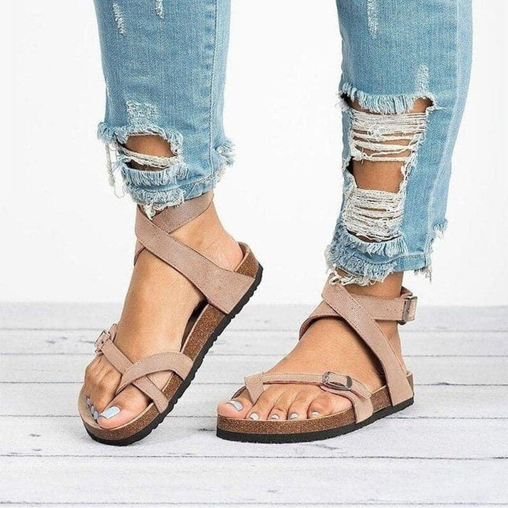 Comfortable women's flat strappy sandals featuring an adjustable buckle. Perfect for walking and casual summer days.
