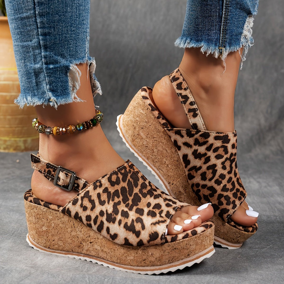 Stylish women's leopard print platform wedge sandals with adjustable buckle strap for casual wear.