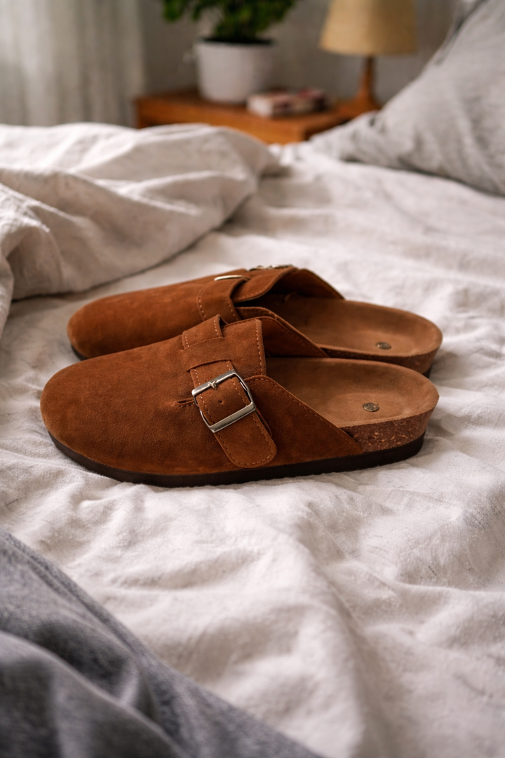 Close-up: casual women's clogs featuring adjustable buckle straps, a comfortable open-heel, and slip-on design.