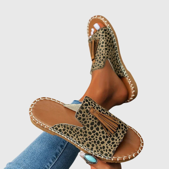 Versatile women's slip-on flat sandals, comfortable with tassel straps for vacation or daily summer style.