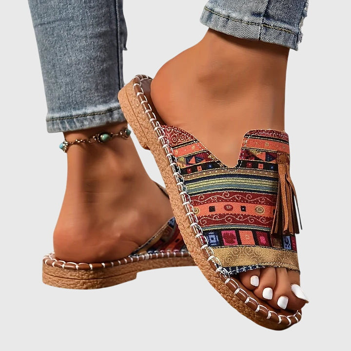 Everyday women's flat sandals, comfortable slip-on with unique tassel straps for a stylish summer look.