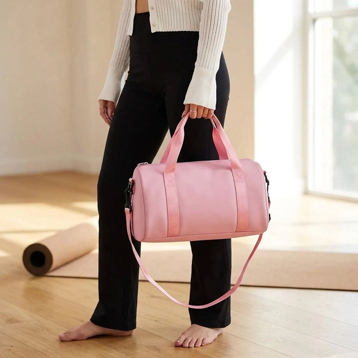 Women's compact mini gym duffel bag in black nylon, perfect for workout essentials and active lifestyles.