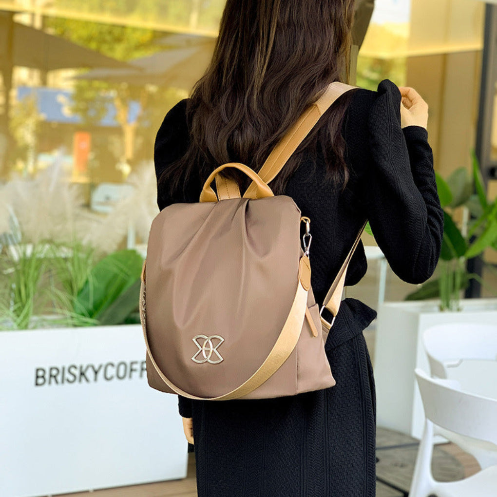 Stylish women's anti-theft commuter backpack. Modern brown convertible bag for secure daily use & fashionable travel.