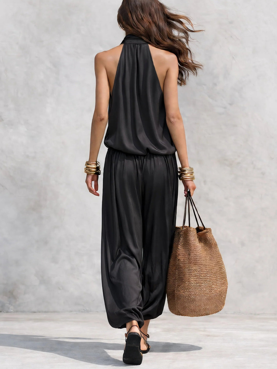 Elegant women's draped cowl neck halter top and wide leg pant set, ideal for evening wear or resort style.