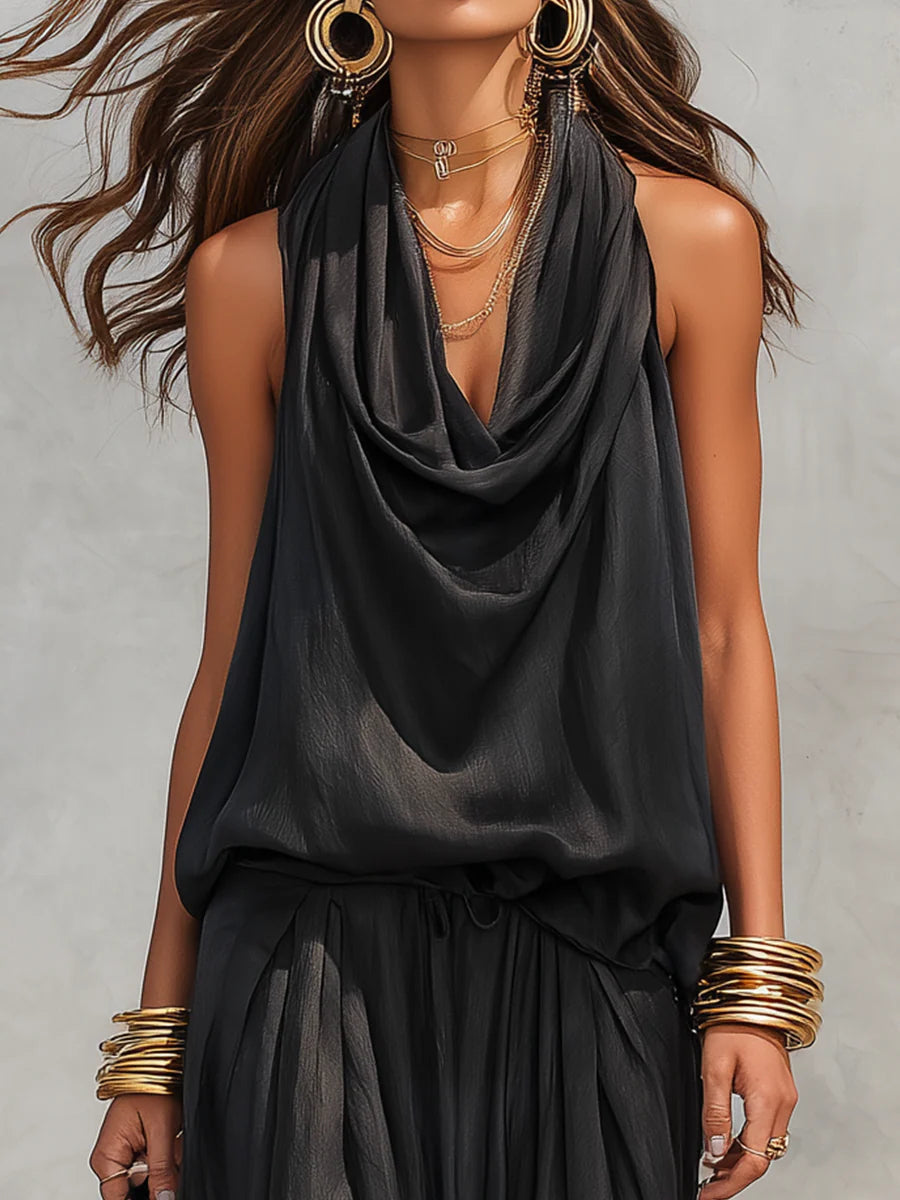 Women's draped cowl neck halter top paired with flowy wide leg pants, a chic two-piece resort outfit.