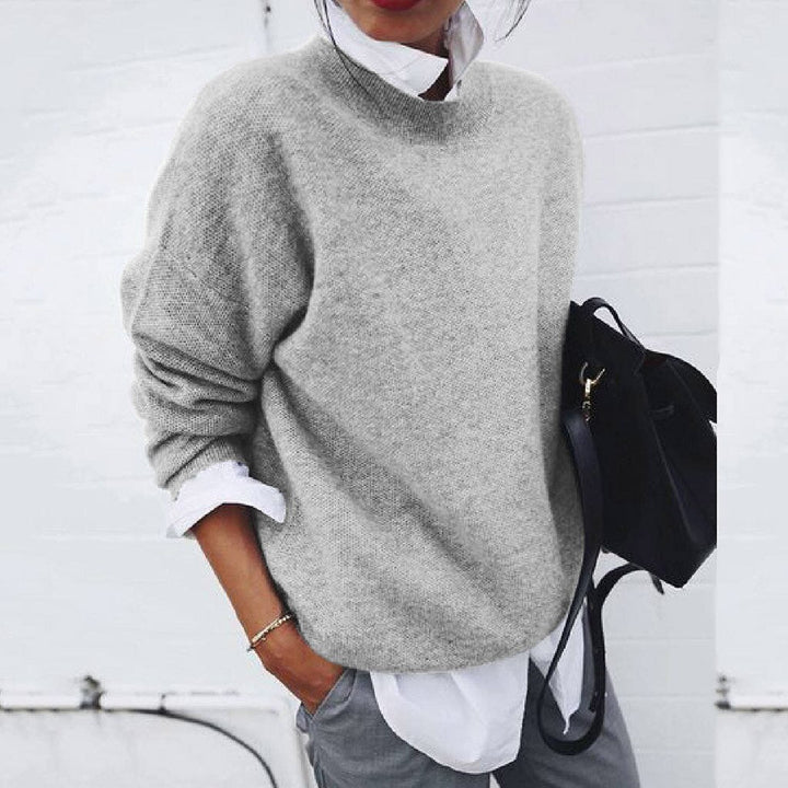 Fine knit warm pullover sweater for women with a comfortable crew neck. Stylish long-sleeve cozy top for fall fashion.