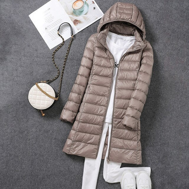 Trendy women's hooded long puffer coat, a fashionable winter outerwear essential for staying warm.