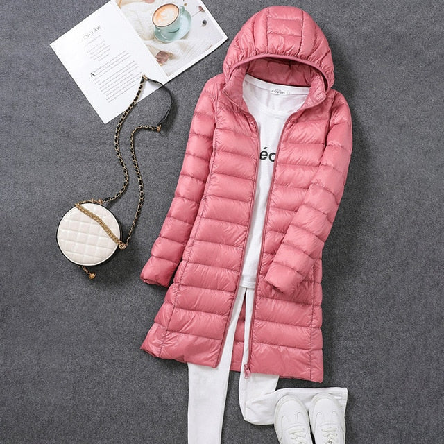 Cozy women's long hooded puffer jacket, practical winter outerwear providing superior warmth & cold comfort.