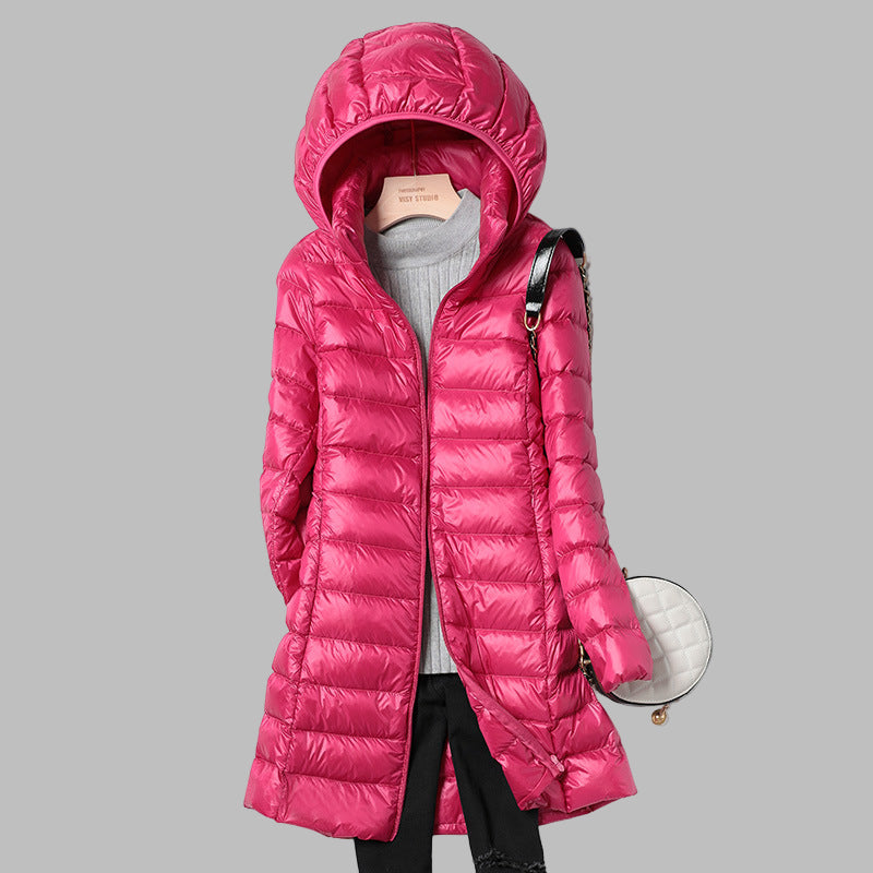 Versatile women's long puffer coat with hood, offering weather protection & warmth for diverse winter conditions.