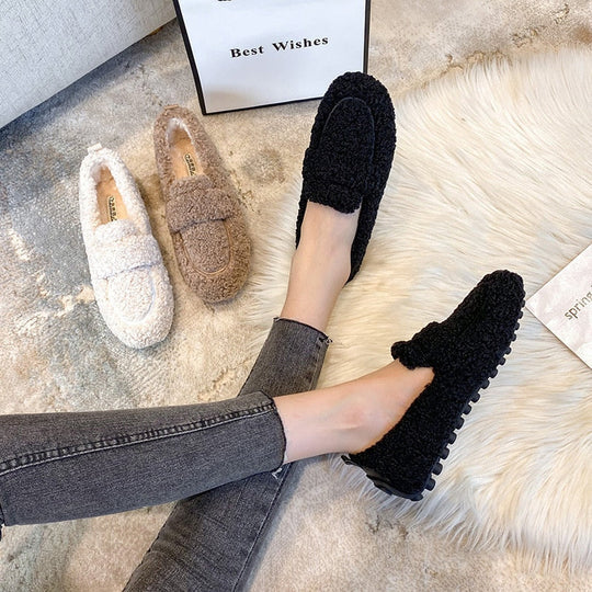 Plush women's cozy loafer slippers, offering soft warmth & cloud-like comfort for home.