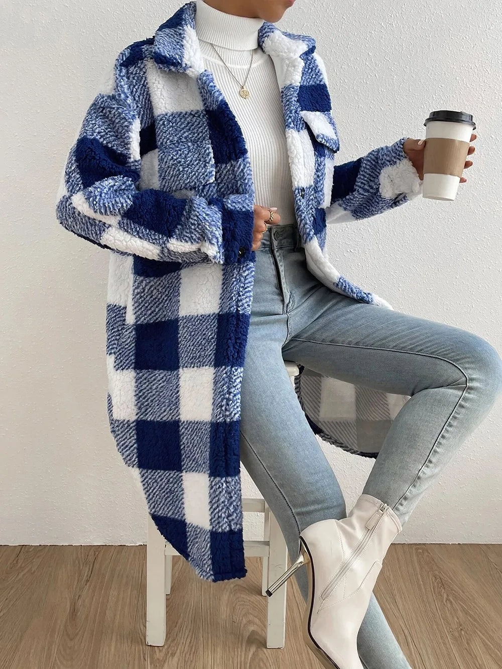 Women's cozy plaid longline jacket, perfect for chilly fall days. Features button-up front & stand collar.