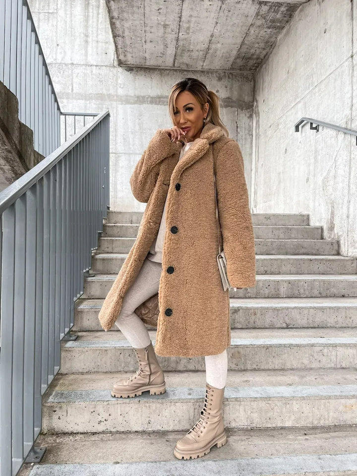 Comfortable women's plush longline teddy coat. A cozy and stylish jacket for chic winter fashion.