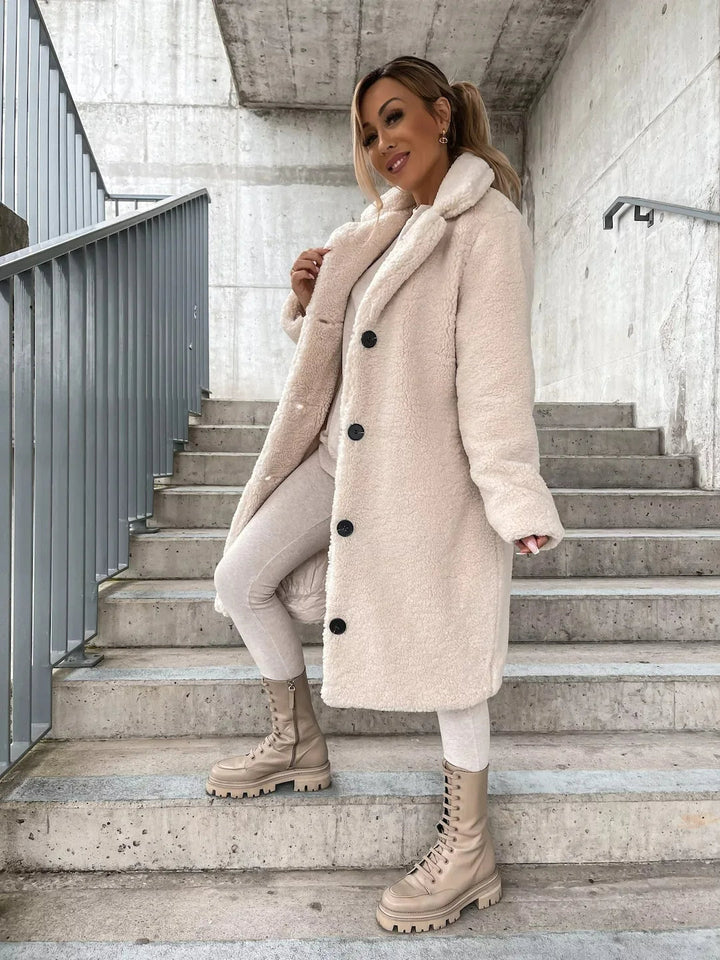 Luxurious plush teddy longline coat for women. Soft, chic, and warm outerwear for winter fashion.