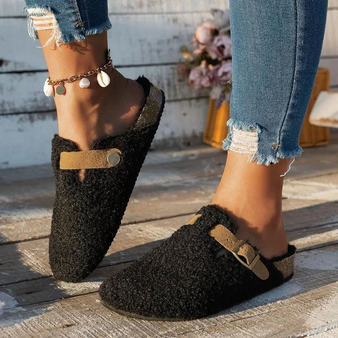 Inviting women's cozy slip-on mules in a warm hue, promising winter comfort & stylish home relaxation.