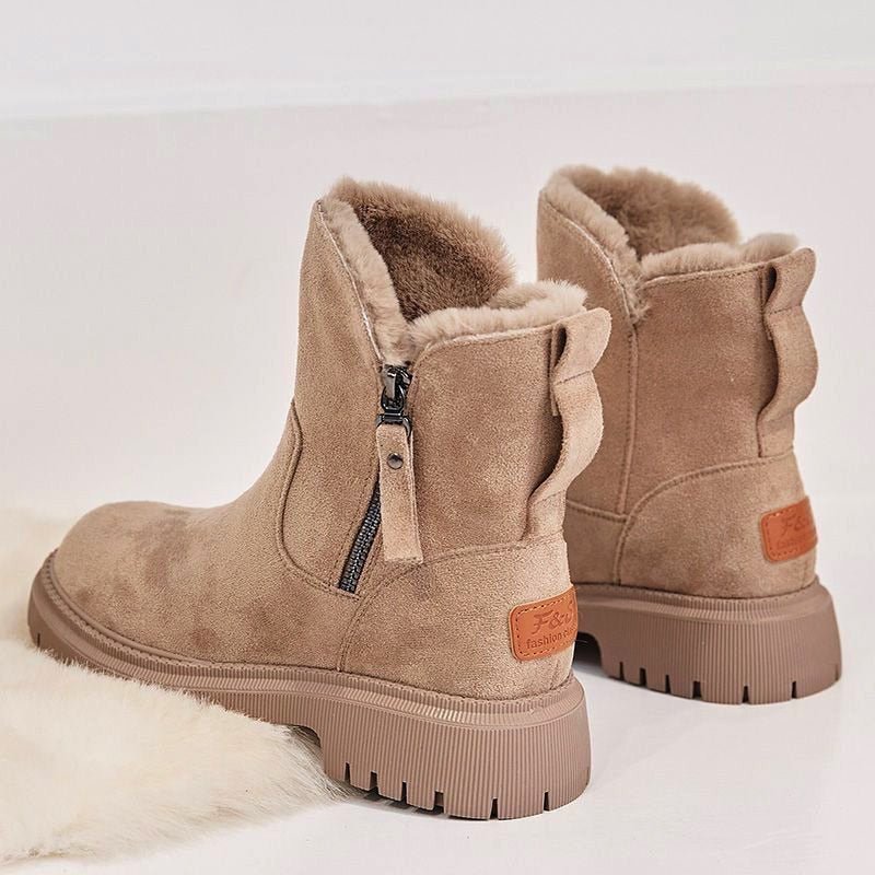 Durable women's insulated winter boots with secure lacing, designed for superior warmth and grip on snow.